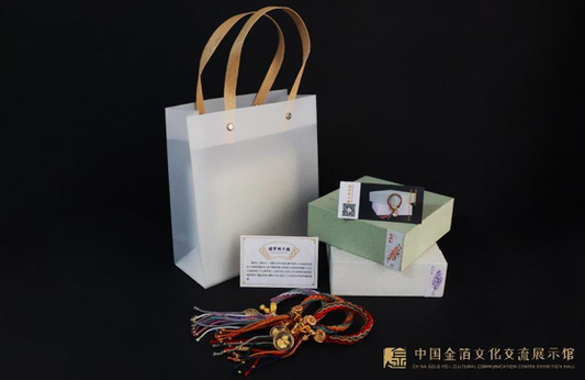 Gold leaf dreamcatcher bracelet presented in gift-ready packaging
