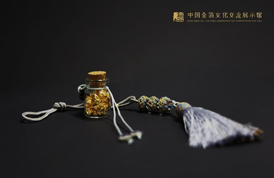Handmade glass vial filled with genuine gold leaf
